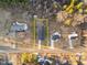 Aerial view showcasing property lines, house, road, and surrounding trees at 1101 Ridge Rd, Roxboro, NC 27573