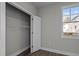 Bedroom with an open closet and a window providing natural light at 1101 Ridge Rd, Roxboro, NC 27573