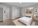 Comfortable staged bedroom with wood floors, a large closet, and natural light from the window at 1101 Ridge Rd, Roxboro, NC 27573