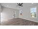 Spacious bedroom features hardwood floors, neutral paint, and a bright window at 1101 Ridge Rd, Roxboro, NC 27573