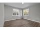 Bright bedroom features hardwood floors, neutral paint, and large windows at 1101 Ridge Rd, Roxboro, NC 27573