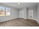 Spacious bedroom features hardwood floors, neutral paint, and large windows at 1101 Ridge Rd, Roxboro, NC 27573