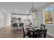 Modern kitchen and dining area with stainless steel appliances, island seating, and stylish pendant lighting at 1101 Ridge Rd, Roxboro, NC 27573