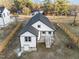An eye-level angle of an adorable two-story home with white siding and brown trim at 1101 Ridge Rd, Roxboro, NC 27573