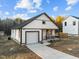 A beautiful exterior featuring a garage and cozy porch, perfect for relaxing outdoors at 1101 Ridge Rd, Roxboro, NC 27573