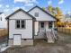A lovely white two-story home with an attractive yard, surrounded by a charming wooden fence at 1101 Ridge Rd, Roxboro, NC 27573