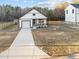 A beautiful exterior featuring a garage and cozy porch, perfect for relaxing outdoors at 1101 Ridge Rd, Roxboro, NC 27573