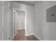 Hallway with wood floors and white trim leading to a laundry room at 1101 Ridge Rd, Roxboro, NC 27573
