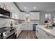 Modern kitchen with white cabinets, stainless steel appliances, and plenty of counter space at 1101 Ridge Rd, Roxboro, NC 27573