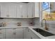 Bright kitchen features white cabinets, granite countertops, subway tile backsplash, and stainless steel faucet at 1101 Ridge Rd, Roxboro, NC 27573
