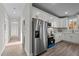 Well-lit kitchen with white cabinets, stainless steel appliances, and modern fixtures at 1101 Ridge Rd, Roxboro, NC 27573