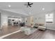 Spacious open-concept living area with sleek hardwood floors, gray sofa, and modern finishes at 1101 Ridge Rd, Roxboro, NC 27573
