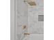 Close up on shower with gold fixtures and marble tile at 1101 Ridge Rd, Roxboro, NC 27573