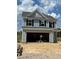 A new construction home featuring light blue siding and an attached two-car garage on a sunny day at 1105 Shovelhead Dr # 40, Durham, NC 27703
