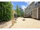 Backyard has a deck, gravel and string lights for backyard gatherings around a fire pit at 1106 Red Crest Ln, Durham, NC 27704