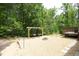 Backyard area featuring a fire pit, hanging chairs and a deck with string lights at 1106 Red Crest Ln, Durham, NC 27704