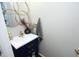 Stylish powder room with navy vanity, gold accents, and unique flower mirror at 1106 Red Crest Ln, Durham, NC 27704