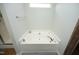 Soaking tub in bathroom featuring tile floors and a nearby glass-enclosed shower at 1106 Red Crest Ln, Durham, NC 27704