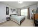 Comfortable bedroom with a bed, dresser, and a large window, creating a relaxing atmosphere at 1106 Red Crest Ln, Durham, NC 27704