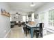 Open-concept dining area featuring a rustic table and chairs, connecting to the living room at 1106 Red Crest Ln, Durham, NC 27704
