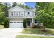 Charming two-story home featuring a two-car garage, front porch, and beautifully landscaped front yard at 1106 Red Crest Ln, Durham, NC 27704
