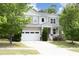 Charming two-story home featuring a two-car garage, front porch, and nicely landscaped front yard at 1106 Red Crest Ln, Durham, NC 27704