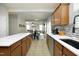 Open-concept kitchen and dining area featuring modern appliances and an island with seating at 1106 Red Crest Ln, Durham, NC 27704
