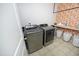 Laundry room features side-by-side washer and dryer, complemented by shelving and storage baskets at 1106 Red Crest Ln, Durham, NC 27704