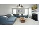 Cozy living room featuring a fireplace, a large sectional sofa, and a ceiling fan at 1106 Red Crest Ln, Durham, NC 27704