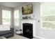 Living room featuring a fireplace, a flat-screen TV, and large windows for ample natural light at 1106 Red Crest Ln, Durham, NC 27704