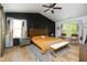 Inviting main bedroom with black accent wall, wooden floors, and ample natural light at 1106 Red Crest Ln, Durham, NC 27704