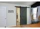 Charming main bedroom with a barn door leading to the en suite bath and unique wall decor at 1106 Red Crest Ln, Durham, NC 27704