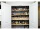 Pantry featuring wooden shelves with a variety of spices and food items, with patterned wallpaper at 1106 Red Crest Ln, Durham, NC 27704