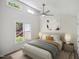 Cozy bedroom with a plush bed, warm lighting, modern ceiling fan, and bright natural light at 112 Carmichael Ct, Cary, NC 27511
