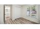 Bedroom with wood-look floors, double closet, and natural light from the window at 112 Carmichael Ct, Cary, NC 27511
