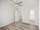 Clean bedroom with luxury vinyl plank flooring, bright natural light, ceiling fan, and closet space at 112 Carmichael Ct, Cary, NC 27511