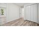 Spacious bedroom showcasing wood-look floors, a double closet, and ample space at 112 Carmichael Ct, Cary, NC 27511
