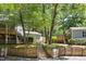 Scenic view showcasing the lush, tree-filled community, stairs, and well-maintained exteriors of several units at 112 Carmichael Ct, Cary, NC 27511