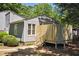 Charming gray cottage with a wooden fence and well-manicured landscaping provides exceptional outdoor privacy at 112 Carmichael Ct, Cary, NC 27511
