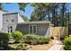 Inviting gray home featuring a cozy front yard with lush green bushes and a charming wooden fence at 112 Carmichael Ct, Cary, NC 27511
