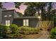 Charming home exterior with lush landscaping, exterior lighting, and a private patio at 112 Carmichael Ct, Cary, NC 27511