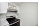 Modern kitchen with stainless steel oven, hood, white cabinetry, and white quartz countertops at 112 Carmichael Ct, Cary, NC 27511