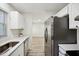 Bright kitchen with stainless steel appliances, quartz countertops, and luxury vinyl plank flooring at 112 Carmichael Ct, Cary, NC 27511