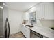Bright kitchen with stainless steel appliances, quartz countertops, and luxury vinyl plank flooring at 112 Carmichael Ct, Cary, NC 27511