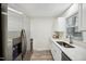 Bright kitchen with stainless steel appliances, quartz countertops, and luxury vinyl plank flooring at 112 Carmichael Ct, Cary, NC 27511