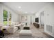 Bright living room features a comfortable white sectional, wood floors, and modern decor at 112 Carmichael Ct, Cary, NC 27511