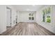 Cozy living room with luxury vinyl plank flooring, bright natural light, and white walls at 112 Carmichael Ct, Cary, NC 27511