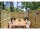 Inviting outdoor dining space with a wooden table and chairs, surrounded by greenery at 112 Carmichael Ct, Cary, NC 27511