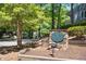 Stone sign for Carmichael Court, surrounded by mature trees, and well-maintained landscaping at 112 Carmichael Ct, Cary, NC 27511