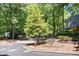 Street view featuring the community sign amongst mature trees at 112 Carmichael Ct, Cary, NC 27511